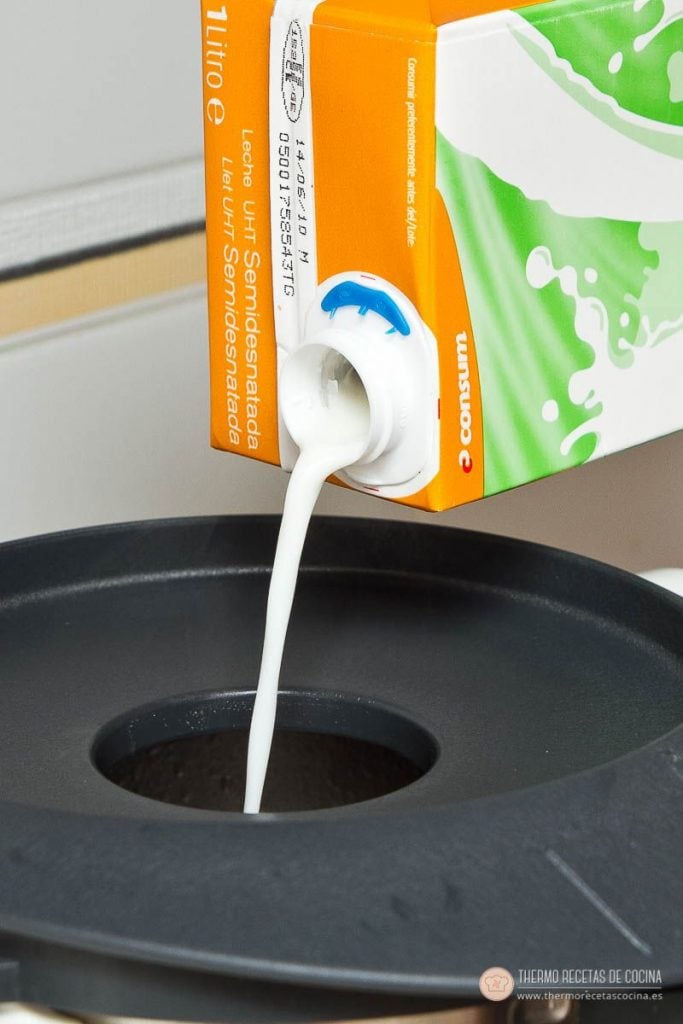leche vertiéndose por el bocal de la tapa de la Thermomix para hacer la bechamel