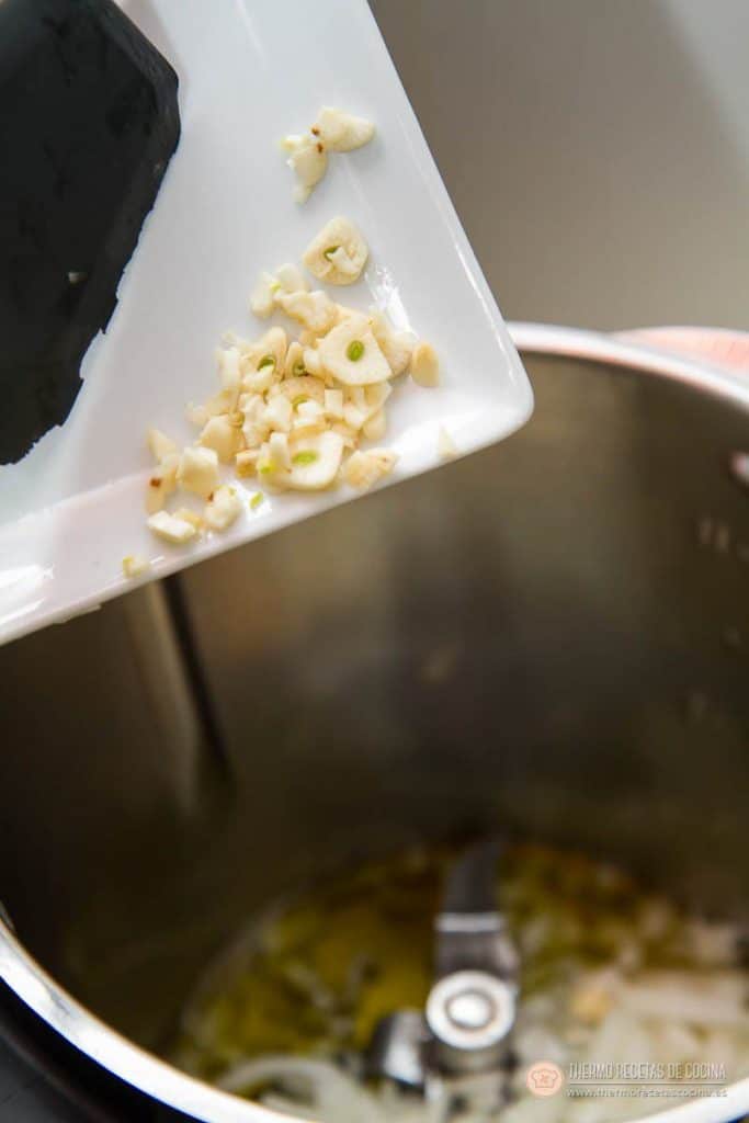 Arroz con pollo y chorizo | 6 | Recetas de cocina para Thermomix Ajo picado añadiéndose al vaso junto a la cebolla